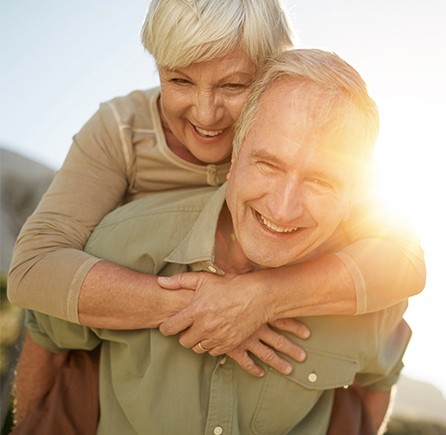 Smiling older man and woman outdoors