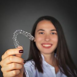 woman holding Invisalign