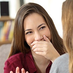 Woman covering her mouth