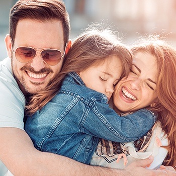 Mother father and daughter smiling together