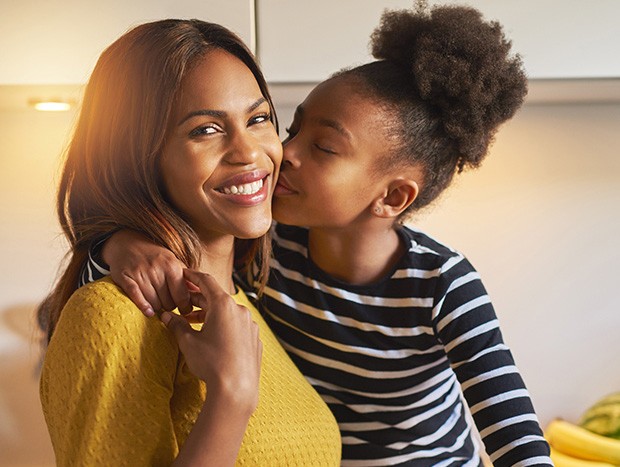 Daughter giving her mother a kiss on the cheek