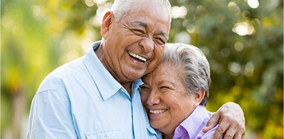 Smiling man and woman outdoors