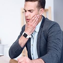 Man holding his jaw in pain