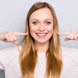 woman pointing to her teeth