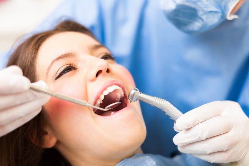 woman dental chair undergoing oral examination