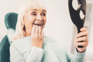 Smiling woman with regained confidence from dental implants