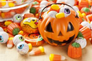 Halloween pail and candy laid out by Skokie dentist